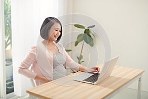 Pregnant Lady In Headset Study With Laptop At Home