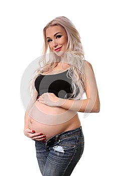 Pregnant lady holding her belly. Close up. White background