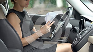Pregnant lawyer reading documents in auto, working during third trimester photo