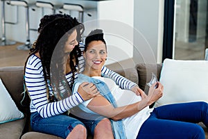 Pregnant lesbian couple looking at sonography report