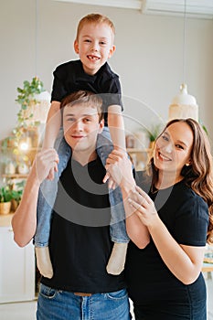 pregnant mom, dad rides son on shoulders. games and relationships with children