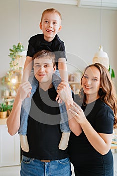 pregnant mom, dad rides son on shoulders. games and relationships with children