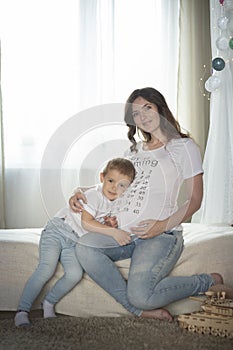 Pregnant mom and son at home