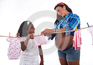 Pregnant mon and daughter playing