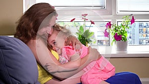 Pregnant mother and blond girl care toy baby doll at home