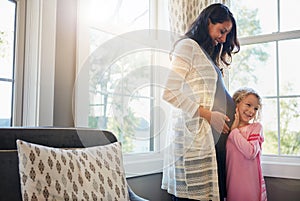 Pregnant, mother and daughter with listening to stomach for baby kick, excited for newborn and curious with smile in