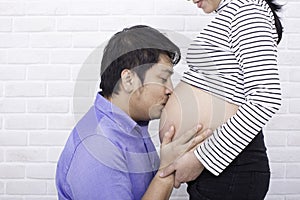 Pregnant mother and father. Young future parent happy together. Father and mother enjoying. Mom and dad. Asian people