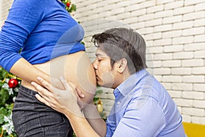 Pregnant mother and father. Young future parent happy together. Father and mother enjoying. Mom and dad standing in the window