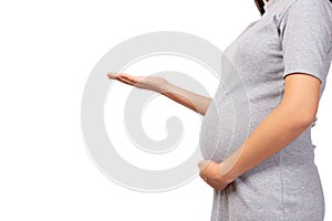 Pregnant mother open palm of hand to copy space and touching her belly. Pregnant woman show empty palm holding. Isolated on white