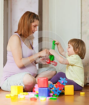 Pregnant mother plays with child