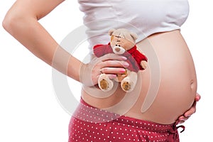 Pregnant mother showing her belly and holding a teddy