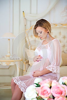 Pregnant mother sitting on a bed of roses