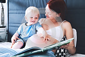 Pregnant mother and son at home.