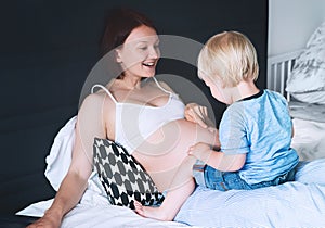 Pregnant mother and son at home.