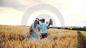 Pregnant mother with toy and basket walks to her family across the field