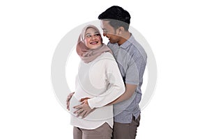 Pregnant muslim wife leaning on romantic husband