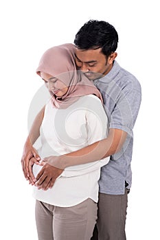 Pregnant muslim wife leaning on romantic husband