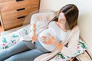 Pregnant time go hospital. Pregnant holding baby belly, woman watching clock. Childbirth time, contractions pain