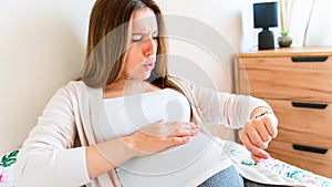 Pregnant time go hospital. Pregnant holding baby belly, woman watching clock. Childbirth time, contractions pain