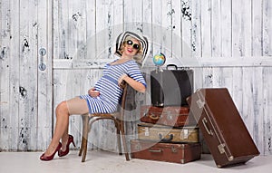 Pregnant tourist with suitcases