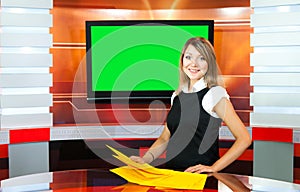 Pregnant tv anchorwoman at tv studio photo