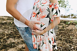 Pregnant wife with husband. Man touching belly of pregnant woman. Family couple waiting for baby.