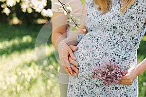 Pregnant wife with husband. Man touching belly of pregnant woman. Family couple waiting for baby.