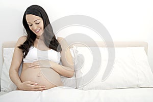 Pregnant woman admiring her bump