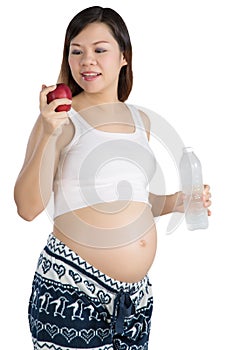 Pregnant woman with apple and bottle on the white background