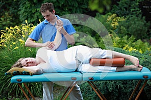 Pregnant woman arm massage by physical therapist