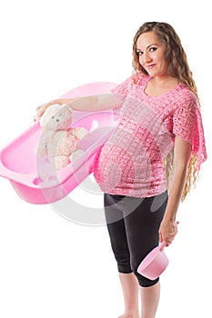 Pregnant woman bathe with toy Teddy bear in tub