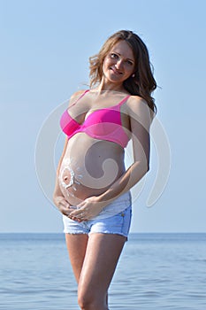 Pregnant woman on beach