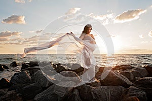 Pregnant Woman on the Beach with Flowing Veil
