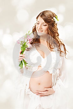 Pregnant woman. Beautiful pregnancy: long curly hair and chiffon