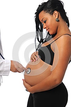 Pregnant woman being examine by a doctor photo
