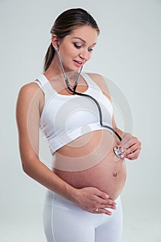 Pregnant woman being examine with stethoscope