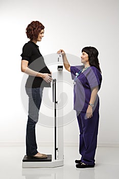 Pregnant woman being weighed.