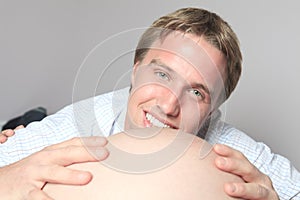 Pregnant woman belly with future father look