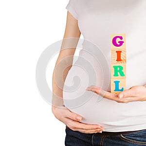 Pregnant woman belly with hands holding wooden blocks with girl sign isolated on white