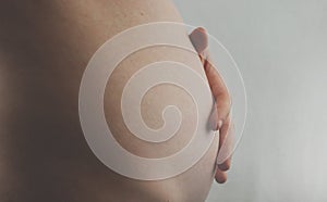 Pregnant Woman Belly. Pregnancy Concept. The third or fourth month. Second trimester. Pregnant tummy close up