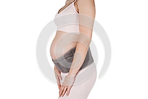 Pregnant woman belly in prenatal pregnancy maternity belt isolated on white background. Support waist, back, abdomen