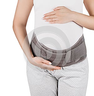 Pregnant woman belly in prenatal pregnancy maternity belt  on white background. Support waist, back, abdomen