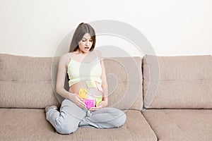 Pregnant woman belly with question mark. Pregnancy and thinking problem