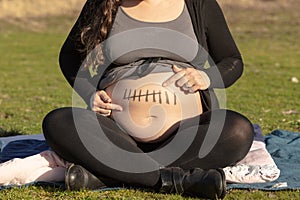 Pregnant woman belly with seven month mark