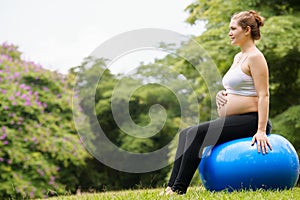 Pregnant woman belly swiss fit ball workout park