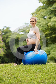 Pregnant woman belly swiss fit ball workout park