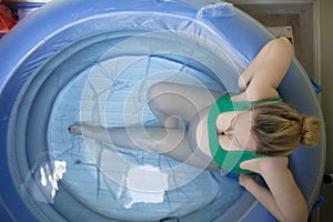 A pregnant woman in a birthing pool during a natural home birth photo
