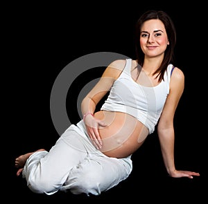 Pregnant woman on black