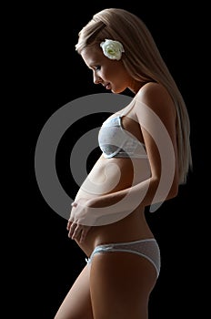 The pregnant woman On a black