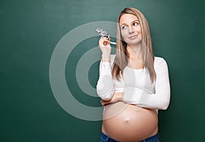 Pregnant woman and a blackboard with copyspace